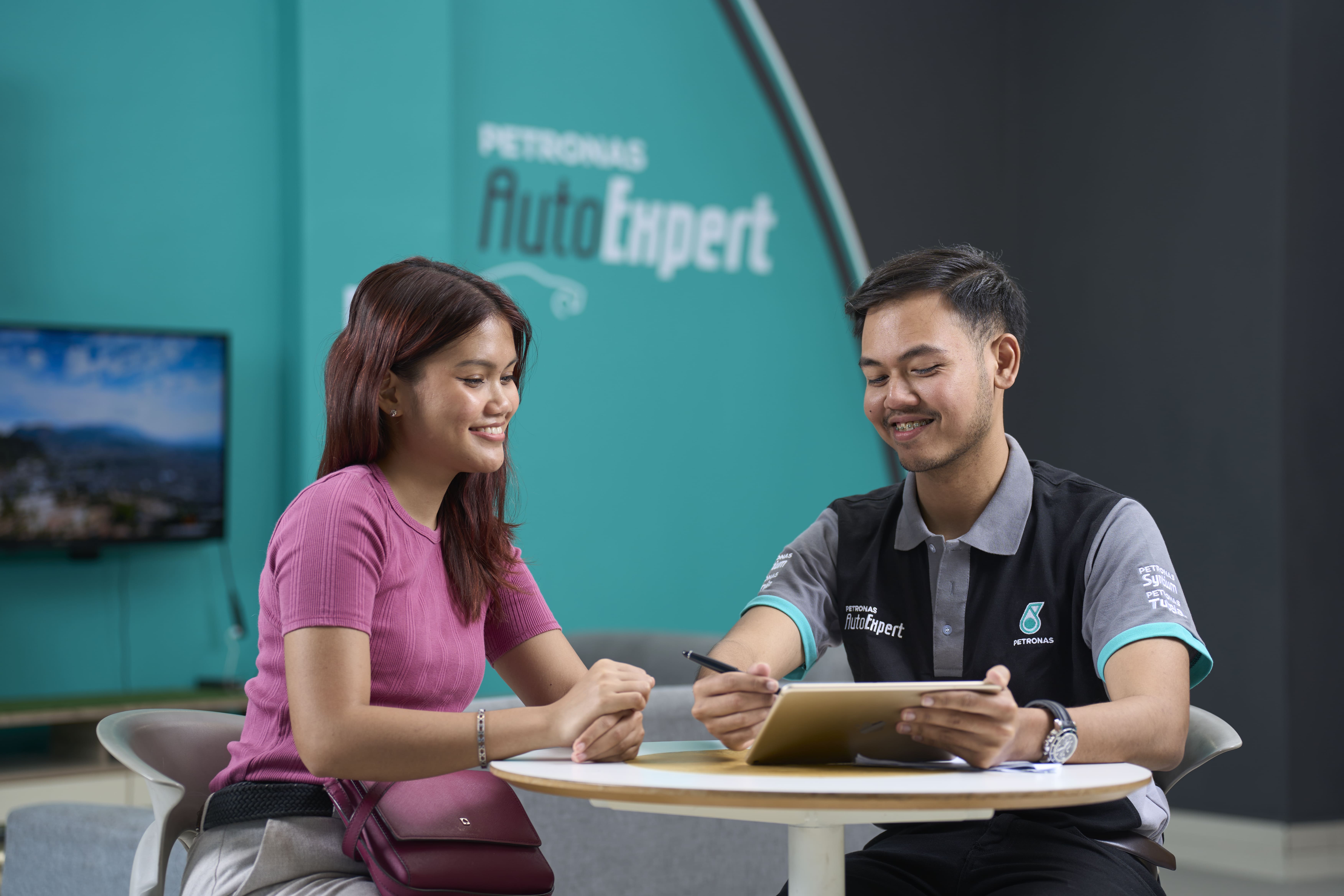 PETRONAS AutoExpert workshop technician servicing a car
